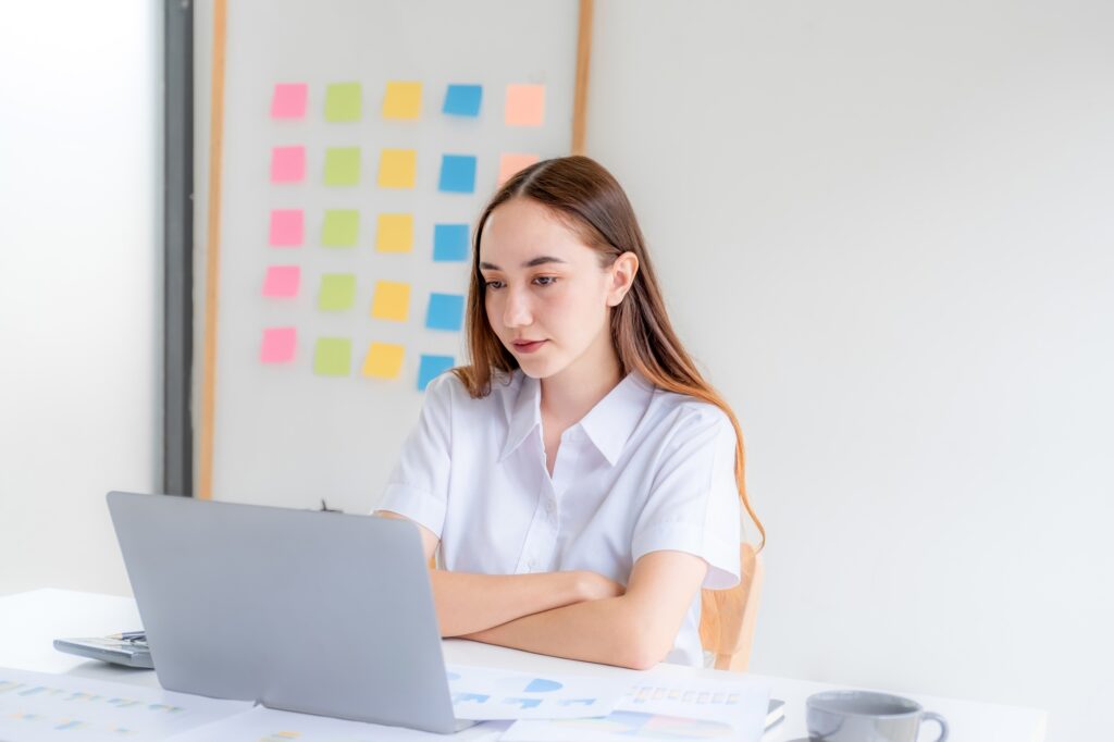 Businesswomen bookkeeper hand use laptop analysis the graph for Setting challenging business goals