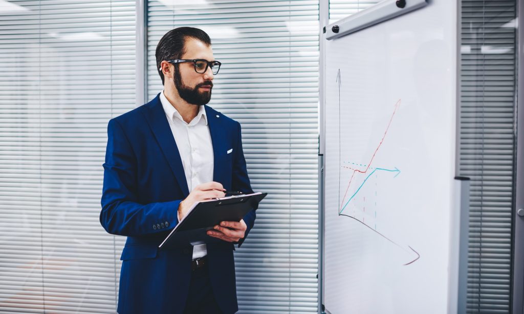 experienced businessman checking revenue marketing diagram