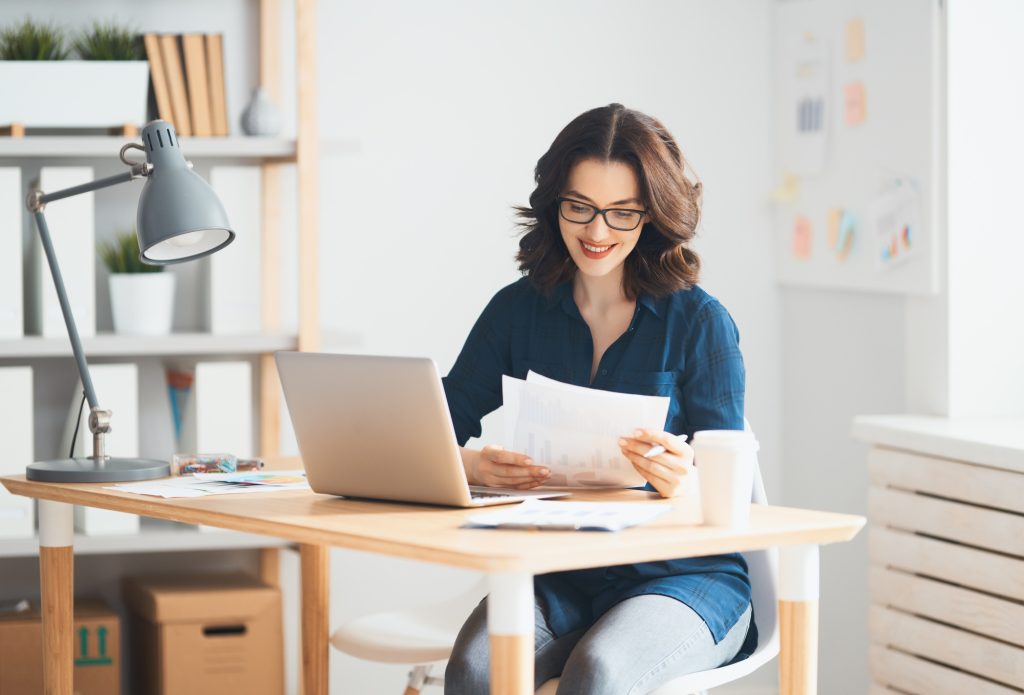 Woman working on a laptop.
