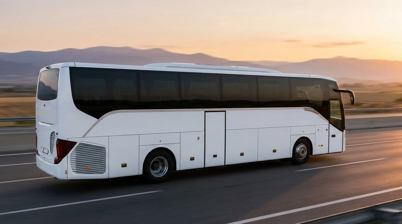 Modern coach bus on a highway showing the high-floor design with luggage compartment underneath