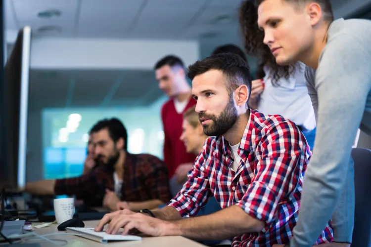 Programmers cooperating at information technology company